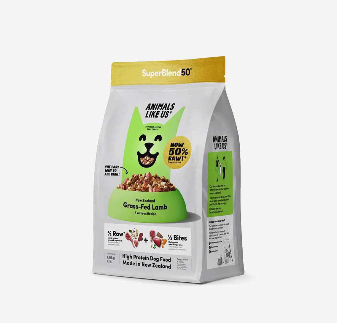 Package of SuperBlend50 dog food featuring grass-fed lamb, labeled "Now 50% Raw!" with playful dog graphic and nutritional information.