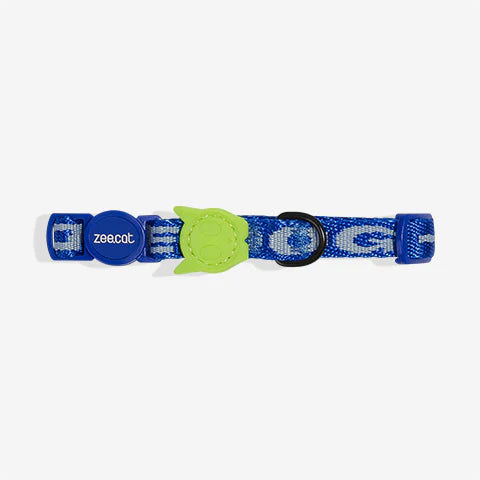 Blue cat collar with green cat skull -shaped breakaway clasp and bell.