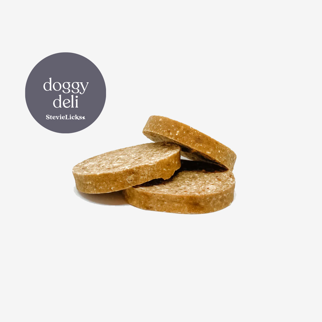 Three round beef and chicken dog treats cookies, stacked together, with a "doggy deli" logo from StevieLicks in the corner.
