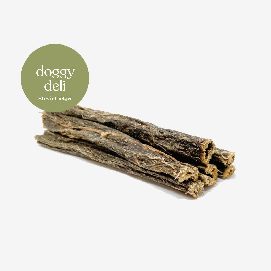 Doggy Deli treats: three chewy beef weesand sticks for dogs, displayed against a clean white background with a circular green logo.