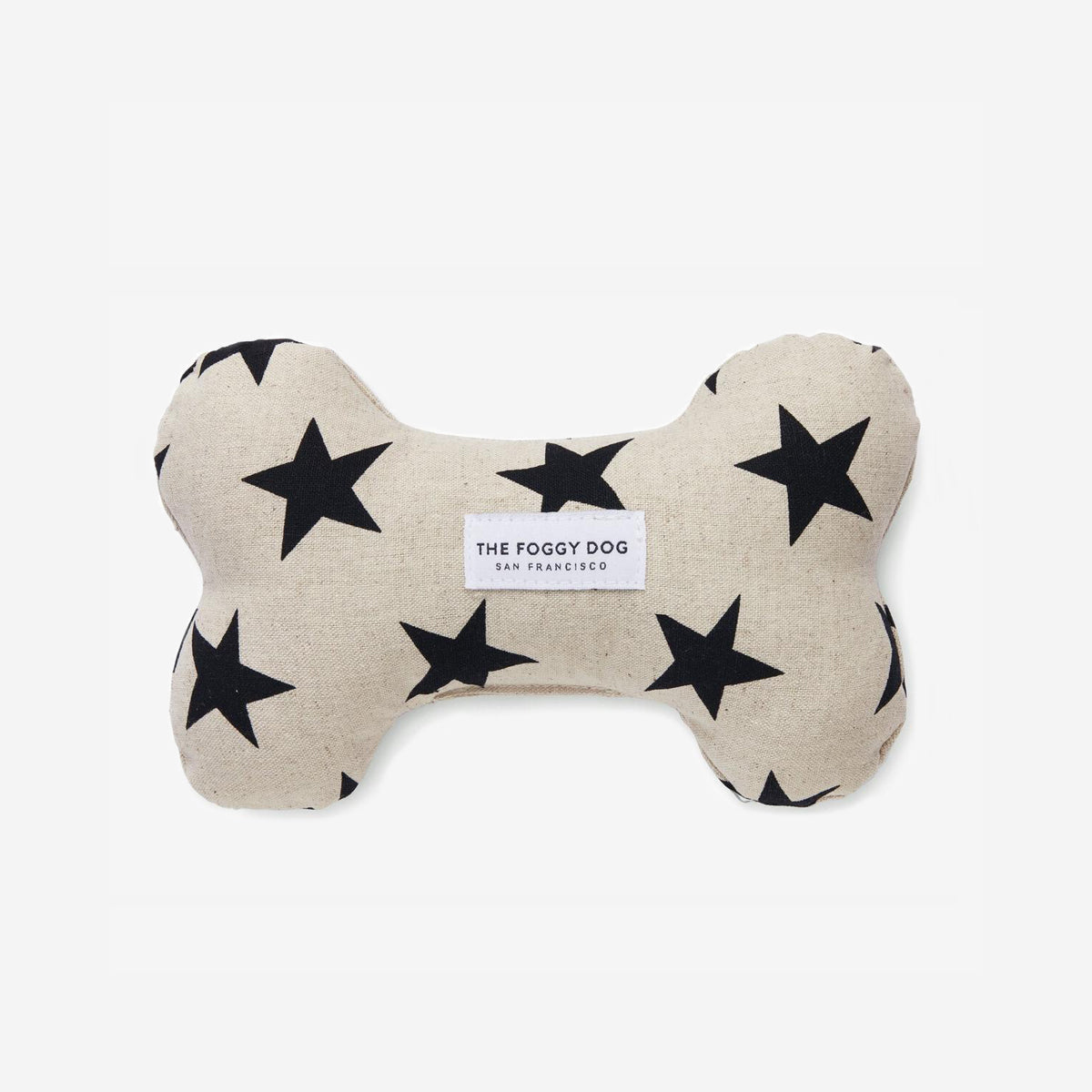 A bone-shaped dog toy with black stars on a beige background and a label 'The Foggy Dog San Francisco'.