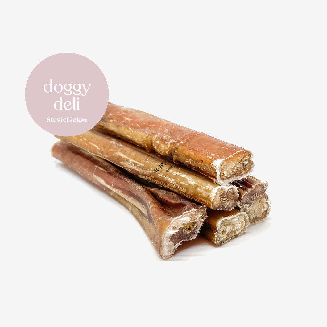 A stack of natural dog chews with a pink logo overlay reading "doggy deli StevieLicks." Perfect for pet treats.