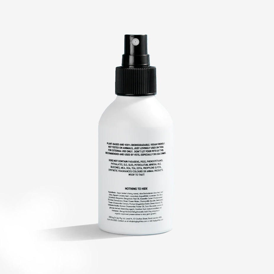 the back of a white dog cologne bottle with a black spray nozzle