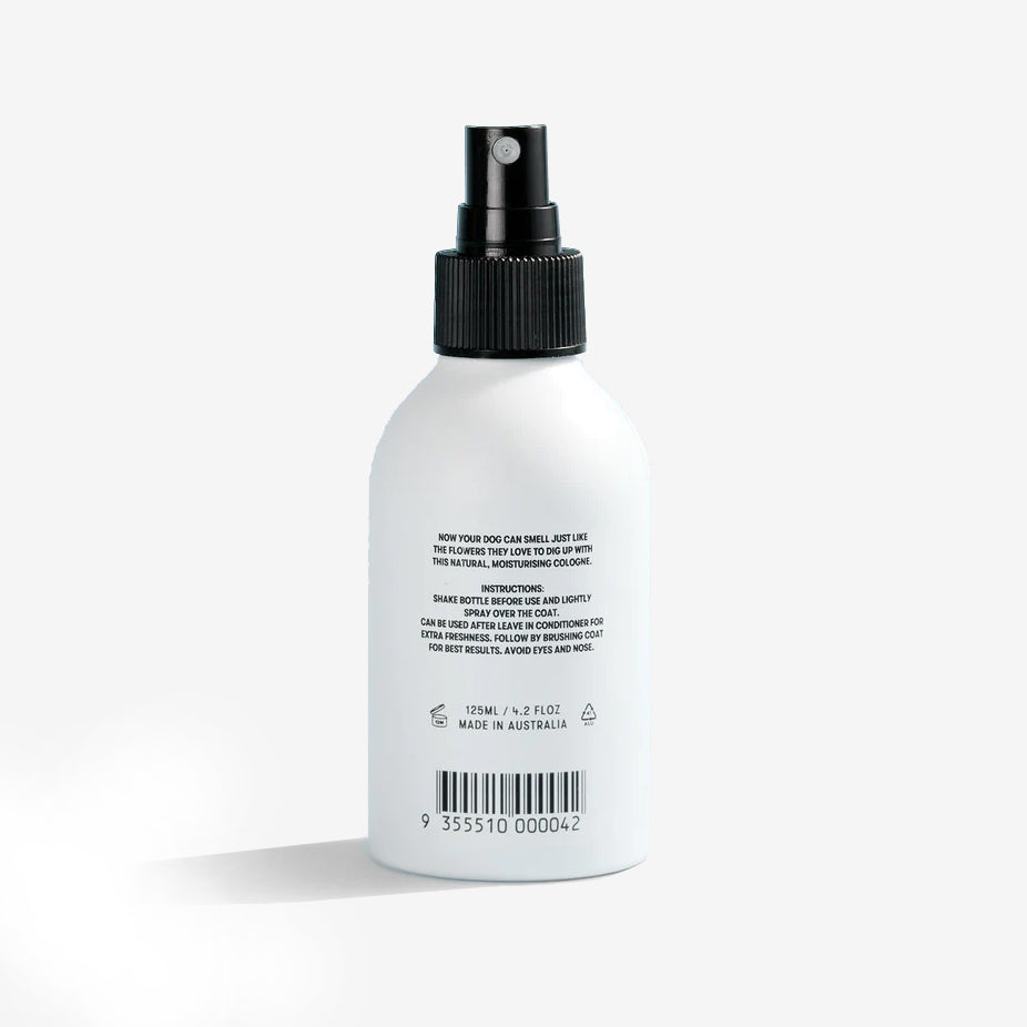 the back of a white dog sweet scented cologne bottle with a black spray nozzle
