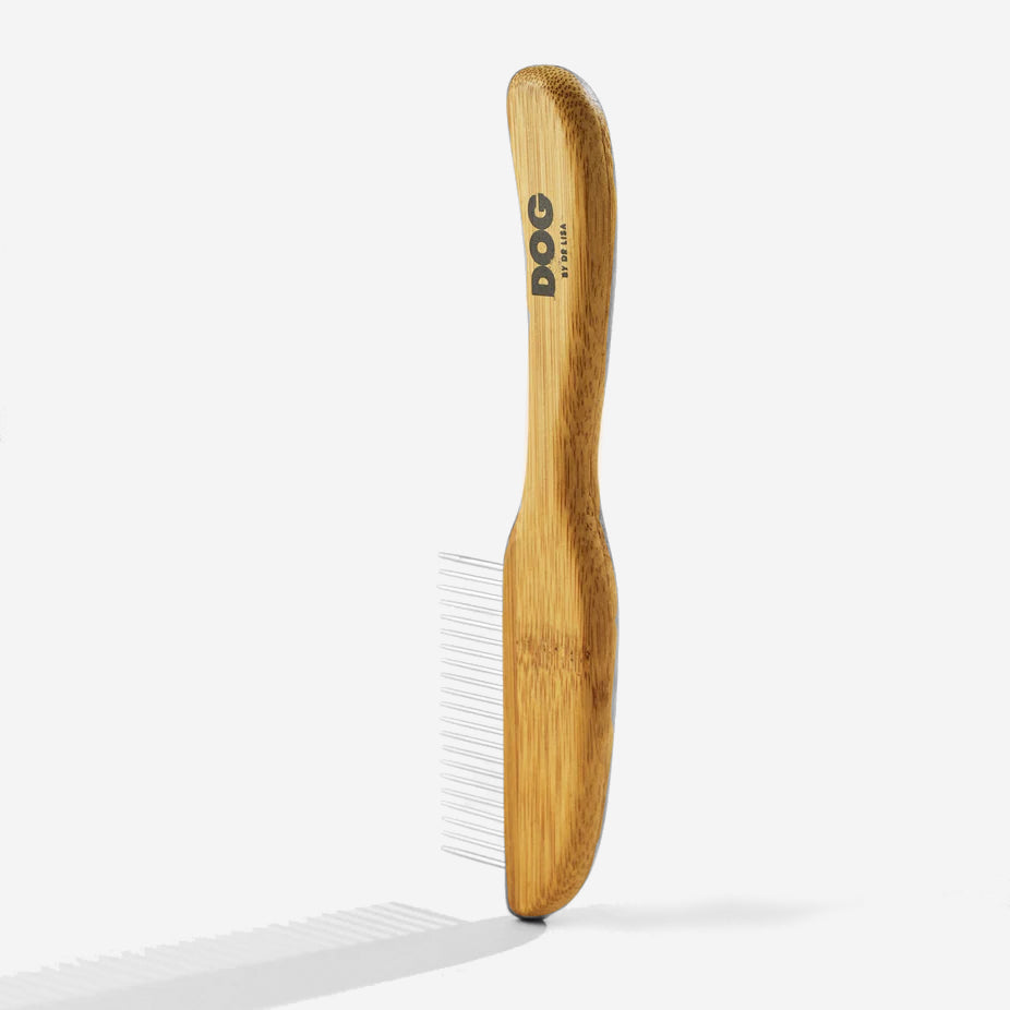 Bamboo wooden dog brush with metal bristles on a white background.