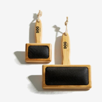 Two sustainable bamboo dog brushes, small and large with black logos on handle and a hessian tie