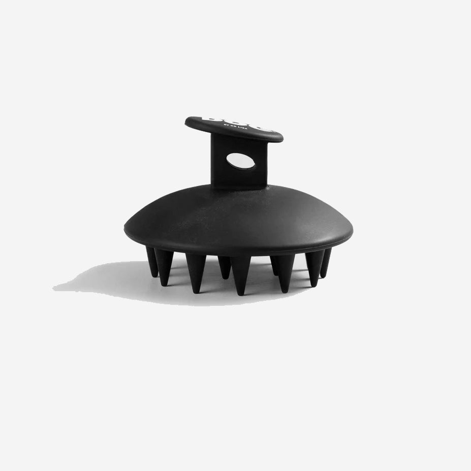 side view of a black silicone wash brush with white dog lettering
