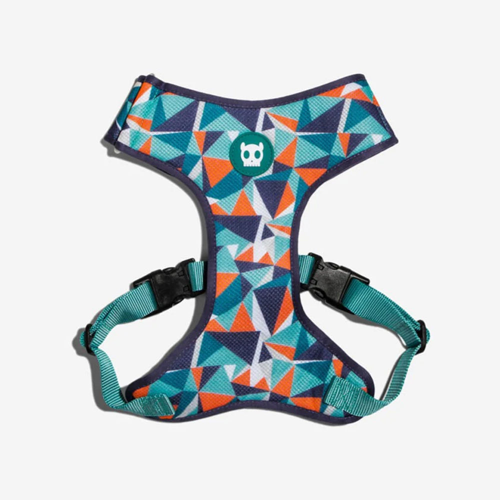 Colourful geometric-patterned dog harness with front skull rubber emblem and adjustable straps.