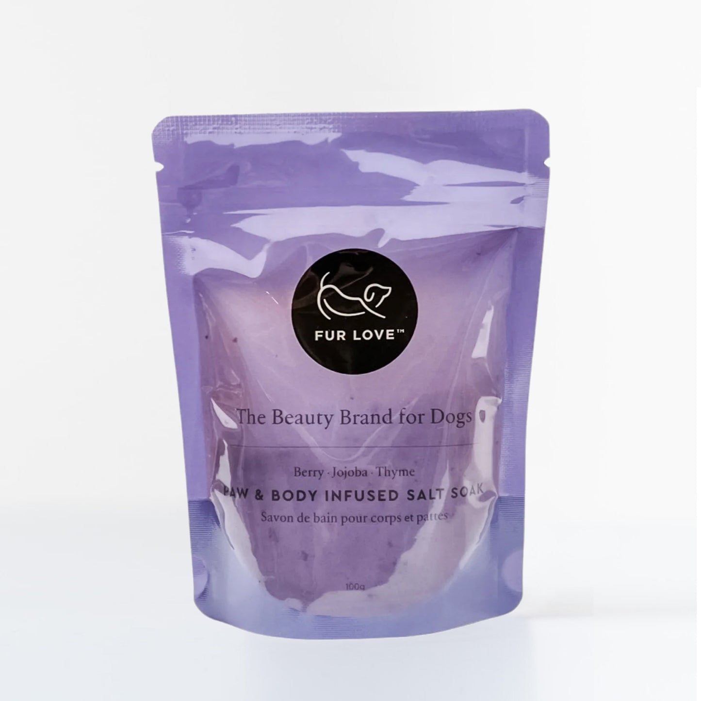 A purple package of Fur Love dog beauty brand infused salt soak with berry, jojoba, and thyme. Standing in a white background.