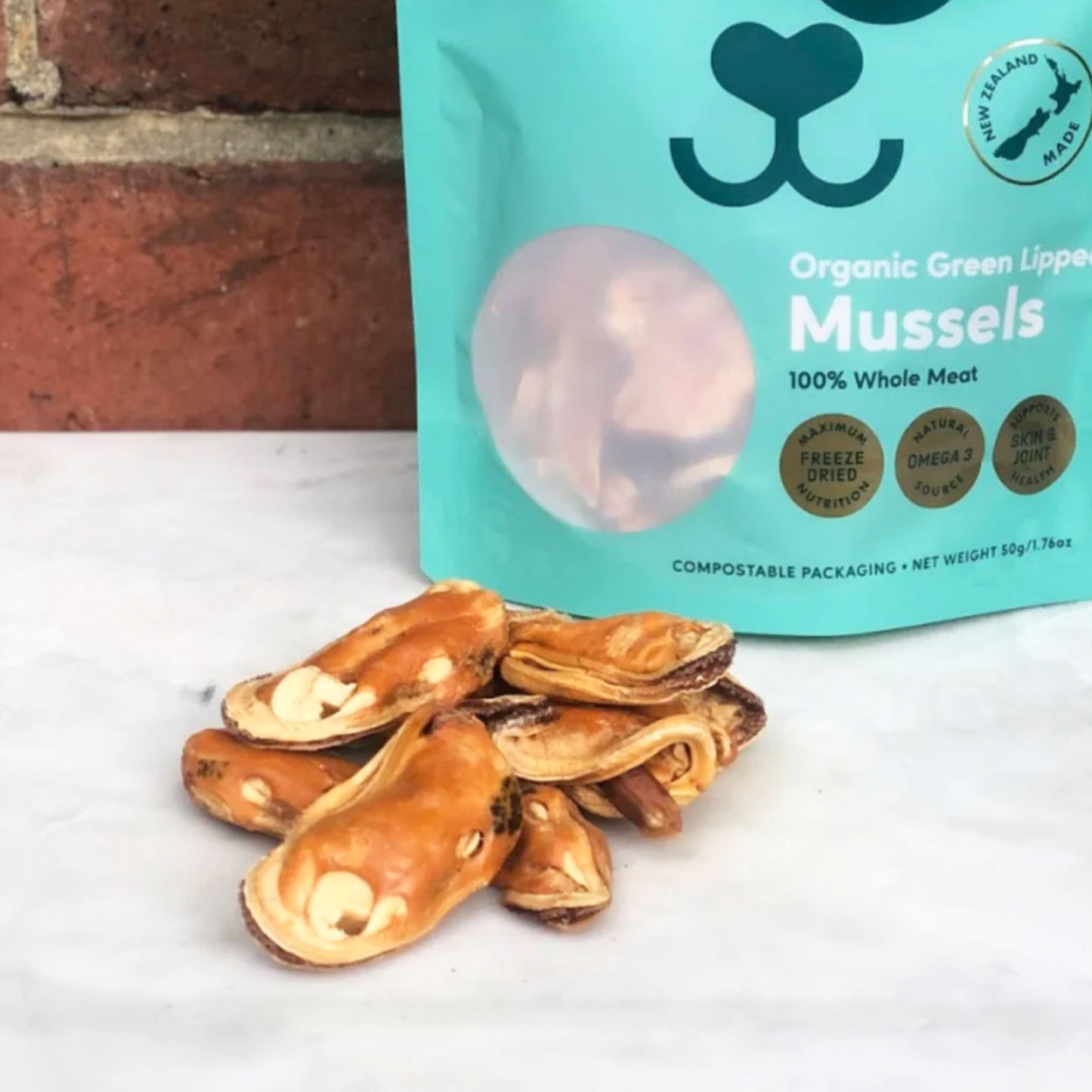 A bag of organic green-lipped mussels for dogs, with freeze-dried mussel meats in front.
