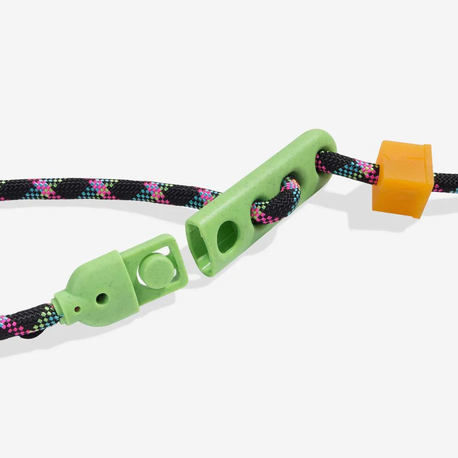 Close-up of a colourful braided cord featuring green and orange plastic adjusters for securing or adjusting length.