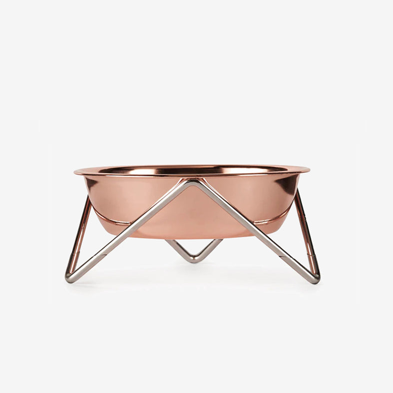 Copper pet bowl on a modern minimalist metallic stand against a white background.