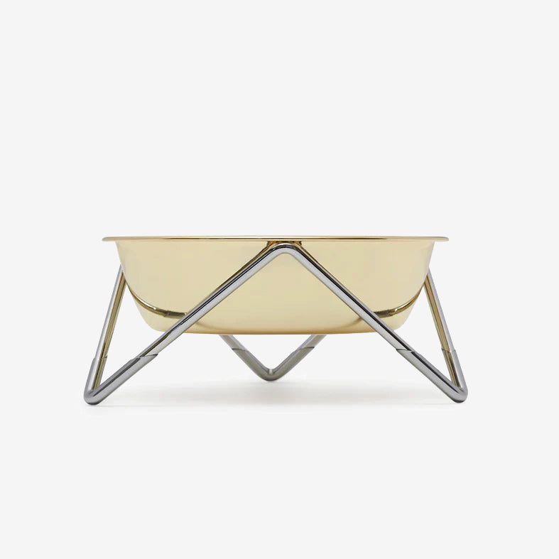 Gold-coloured pet bowl on a chrome stand against a white background.