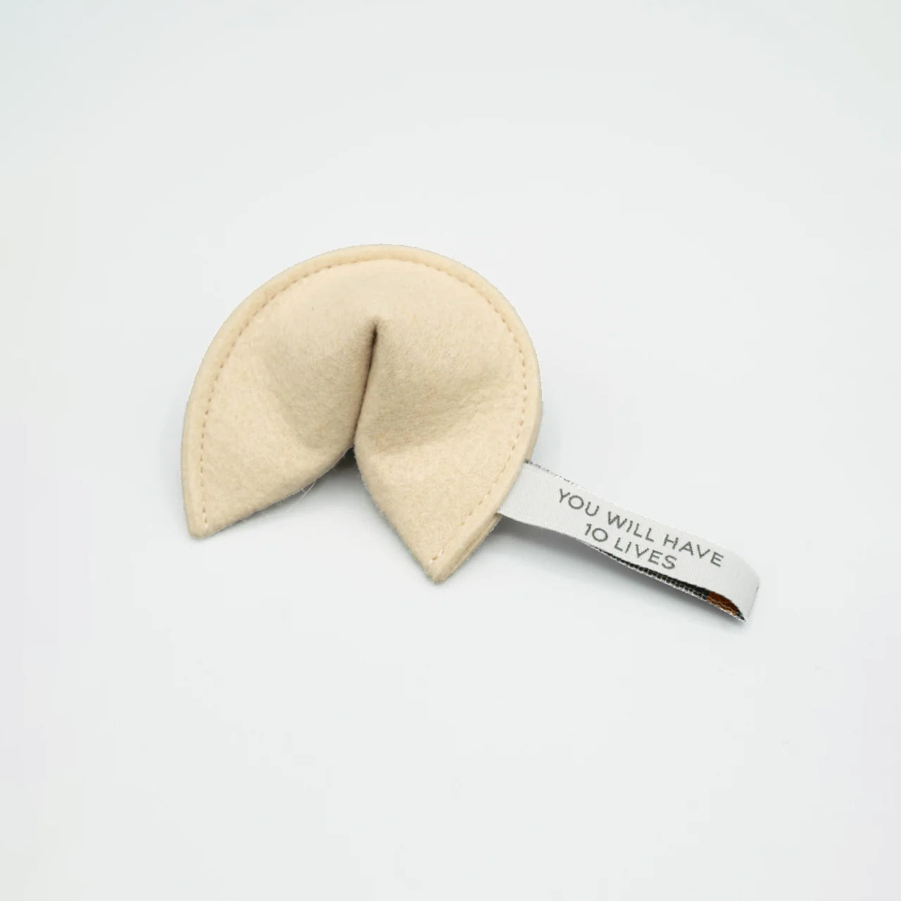 Fortune cookie with message "YOU WILL HAVE 10 LIVES" on white background.