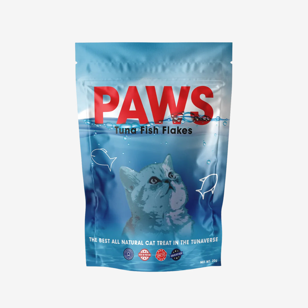 A package of "PAWS Tuna Fish Flakes" cat treats with underwater imagery and a cat's face.