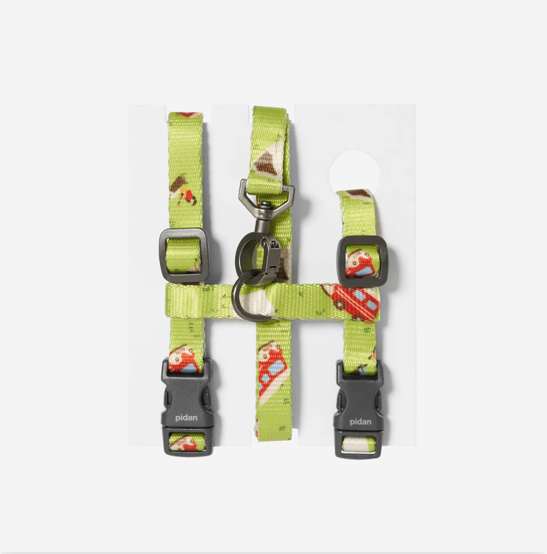 Lime green, cat harness, patterned withred campervans and little people outside camping. Featuring black branded buckles and a galvanised metal hook.