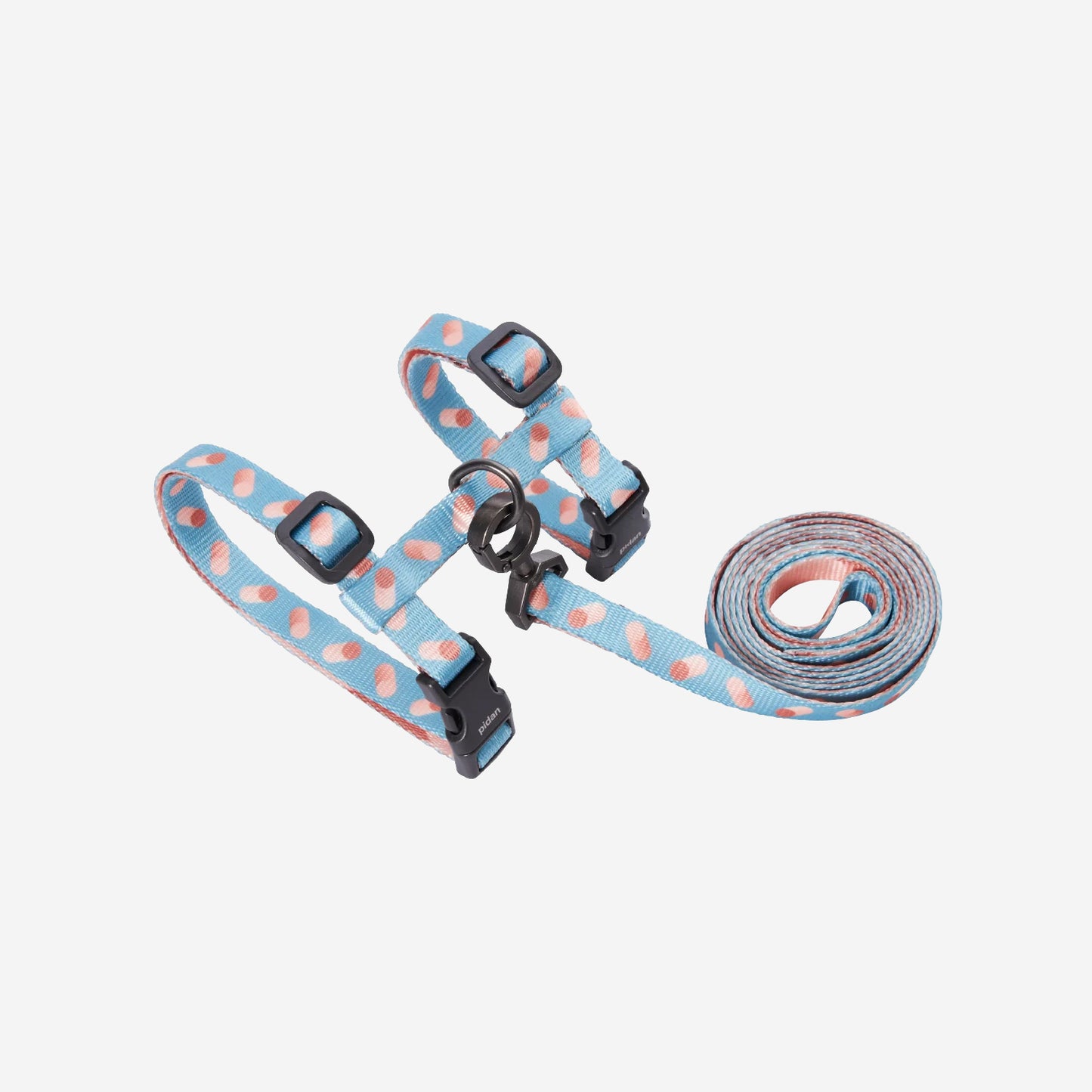 Blue and pink polka-dott and capsule cat harness and leash set on a white background.