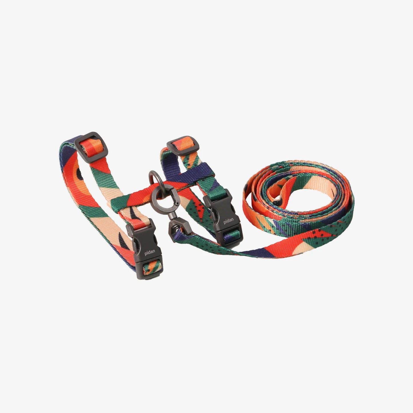 Colourful patterned dog harness and leash set on a white background.