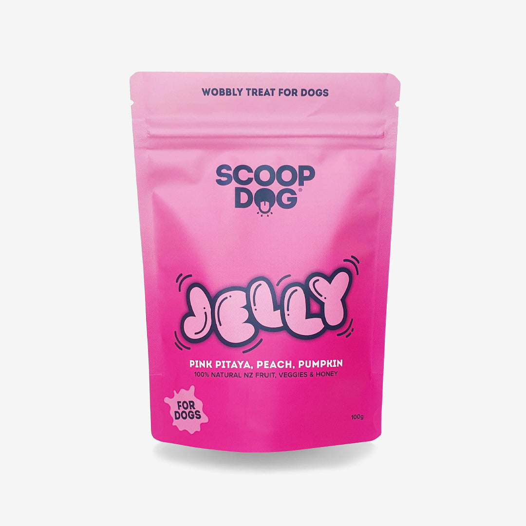 Pink dog treat package labeled "Scoop Dog Jelly" with pink pitaya, peach, pumpkin flavors.