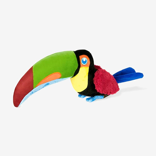Colourful plush toucan toy with a large green and red beak, bright eyes, and soft feathers in black, blue, and maroon.