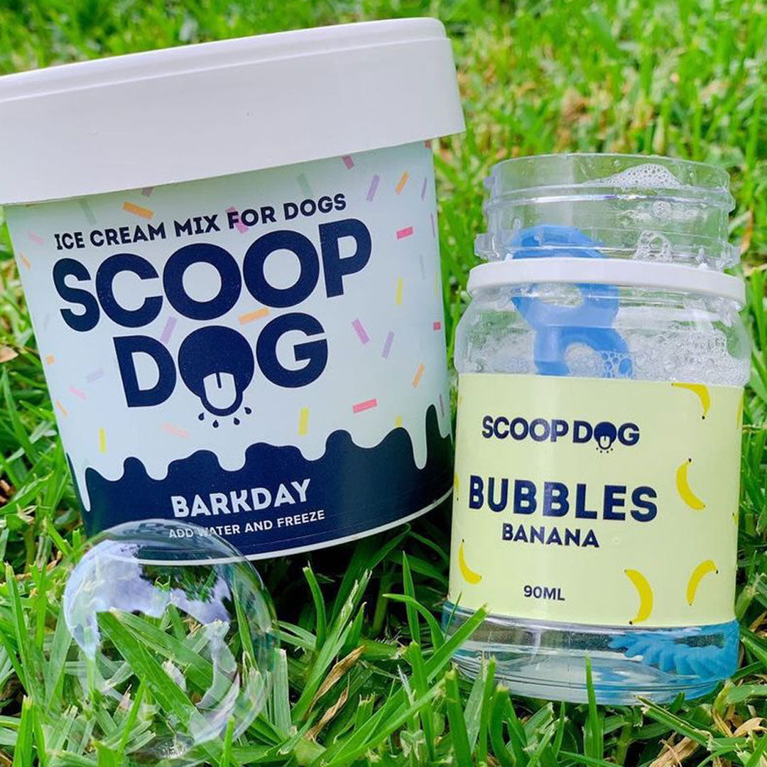 Dog-friendly "Scoop Dog" ice cream mix and "Banana" flavoured bubbles on grass.