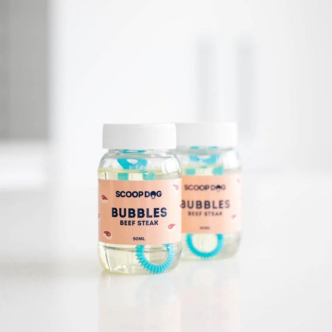 Two bottles of 'ScoopDog Bubbles Beef Steak' on a white surface.