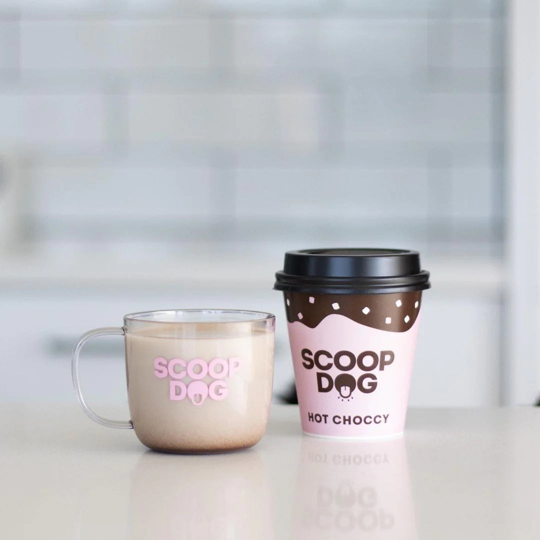 Two beverage containers with "SCOOP DOG" branding, one clear glass mug, one paper takeaway cup.