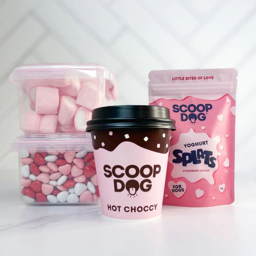 Some dog treats in various packaging with a 'Scoop Dog' brand label on a light background.