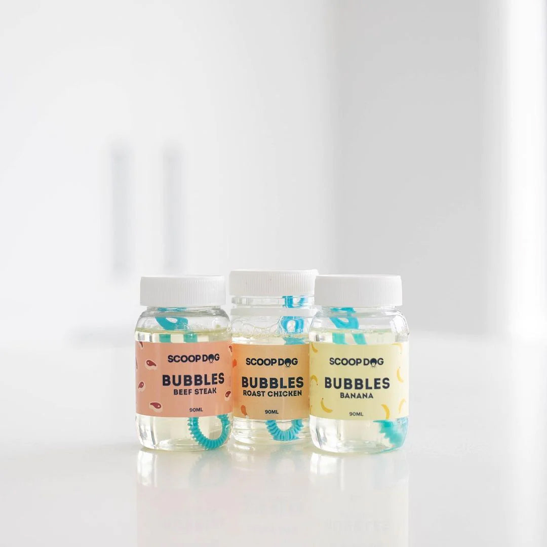 Three bottles of ScoopDog Bubbles dog treats in beef, chicken, and banana flavours.