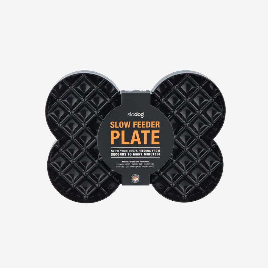 Black slow feeder plate in a bone shape, labeled "Slow Feeder Plate," designed to prolong dog feeding times and prevent digestive issues.