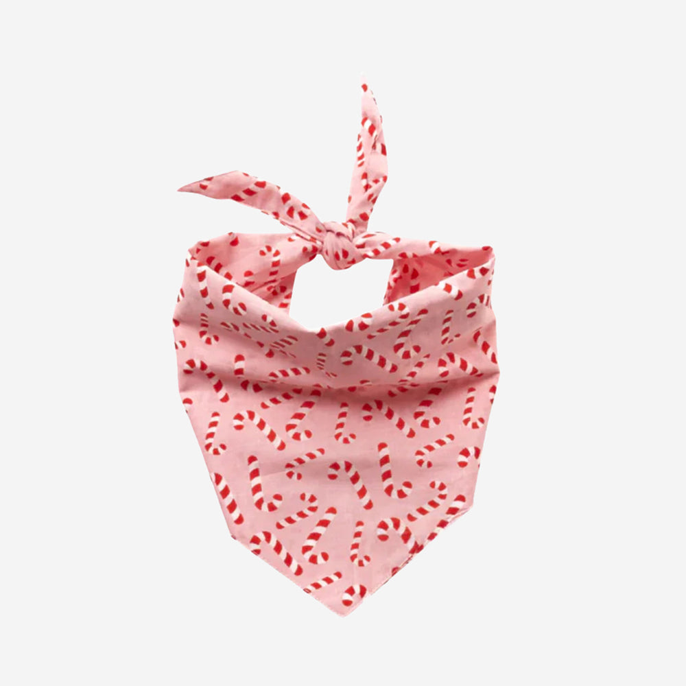 100% cotton dog bandana with a candy cane pattern on a pink fabric.