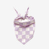 A lilac and white checkered dog bandana, tied neatly on a white background.