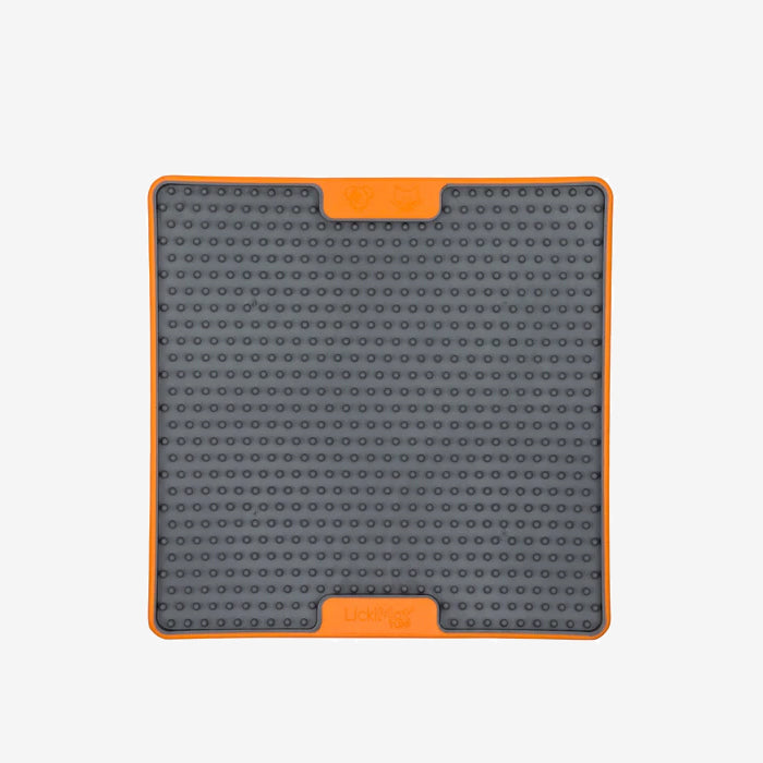 Orange and gret removable pet silicone lickimat mat container with rounded corners and a clean, simple design with 4 rubber dots in each corner.