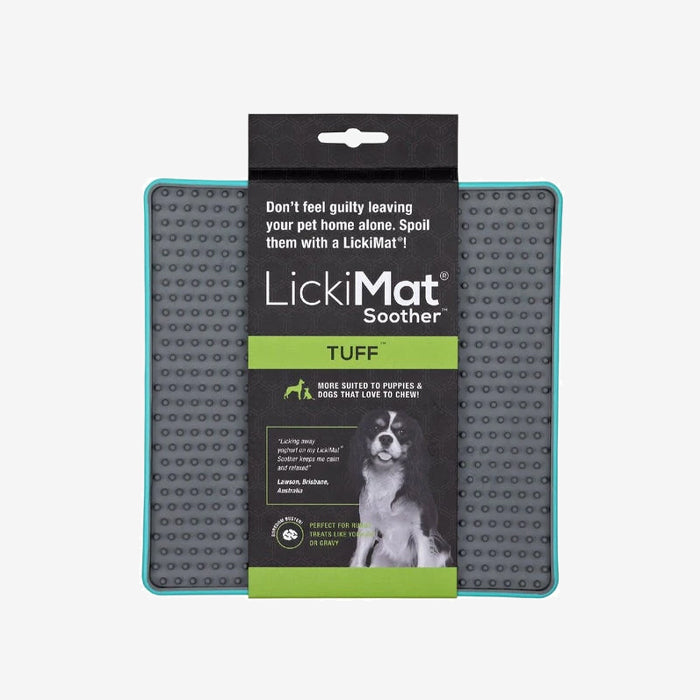 Grey LickiMat Soother TUFF with turquoise rim, a chew-resistant feeding mat for dogs, designed to calm pets while enjoying treats, with a playful dog image.