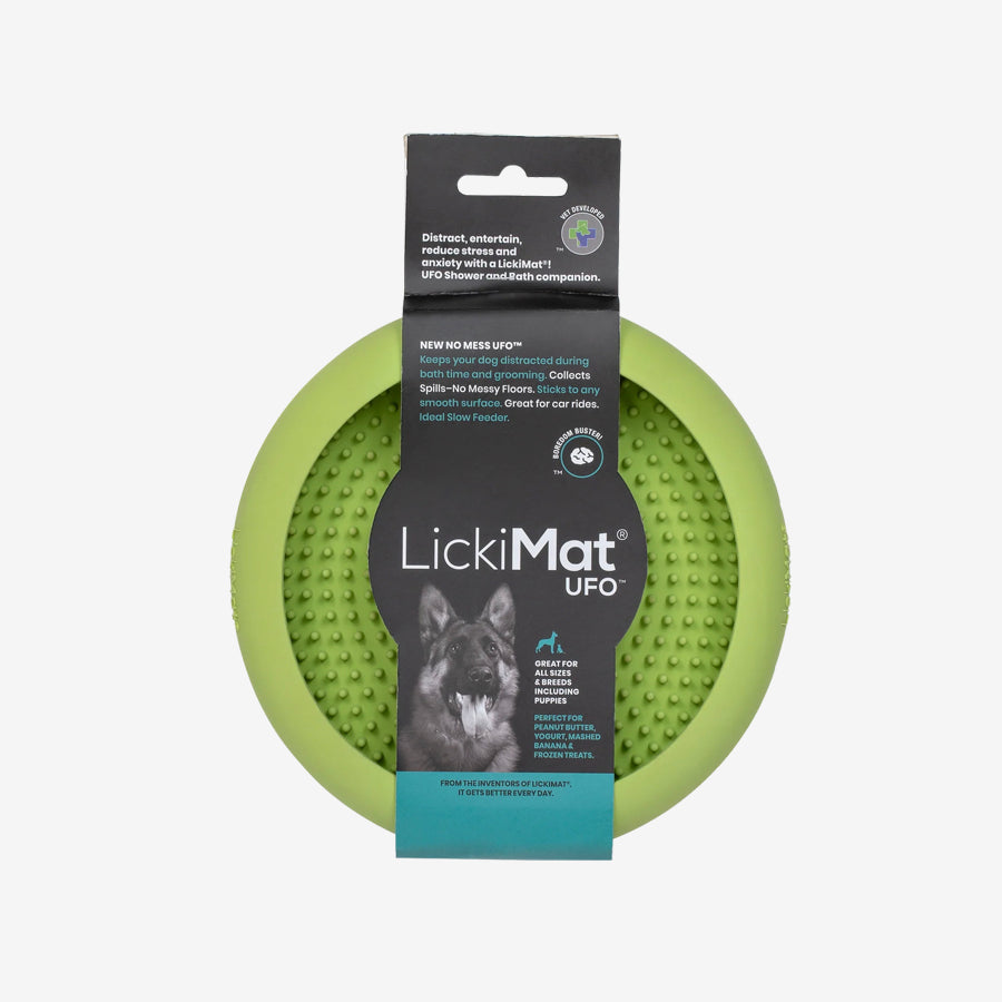 A green LickiMat UFO, designed for dogs, featuring a textured surface for treats and an easy-clean design for bath time distraction.