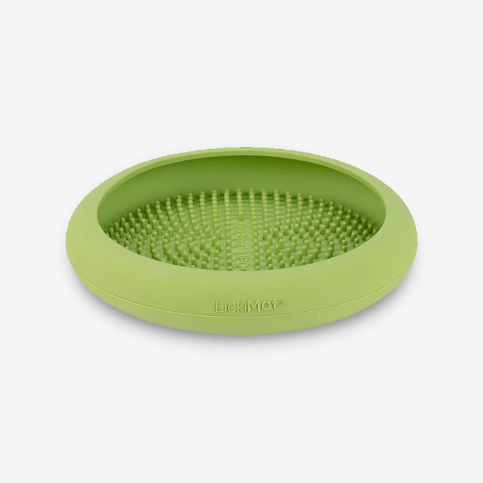 Round green silicone LickiMat with textured surface, designed to engage pets and prevent boredom during mealtime.