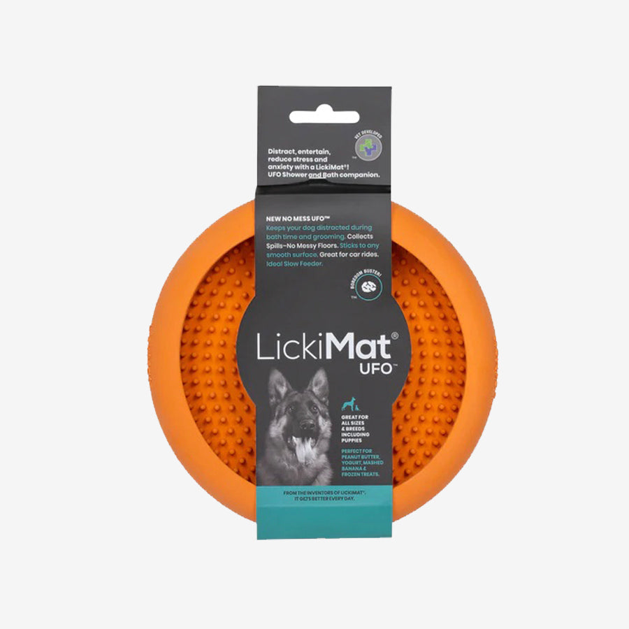 LickiMat UFO in orange, designed to keep dogs distracted during grooming, featuring sticky back and textured surface for treats.