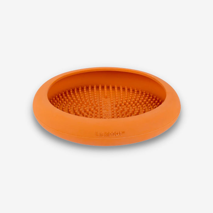 Round orange silicone LickiMat with textured surface, designed for engaging pets during mealtime or as a treat-dispensing mat.