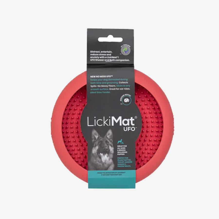 A red LickiMat UFO for dogs, featuring a textured surface to keep pets distracted during bath time, grooming, or slow feeding.