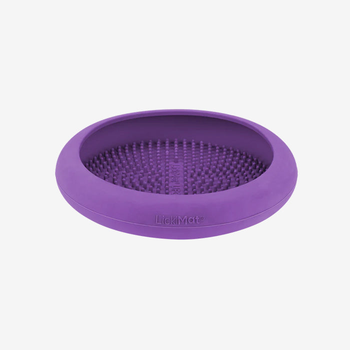 Purple silicone Lickimat with textured surface for spreading pet treats, designed to keep pets engaged and reduce anxiety.