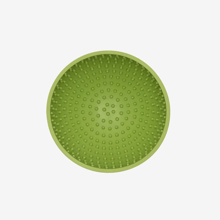 Top view of a round, green silicone mat featuring numerous raised dots for grip or massage, set against a white background.