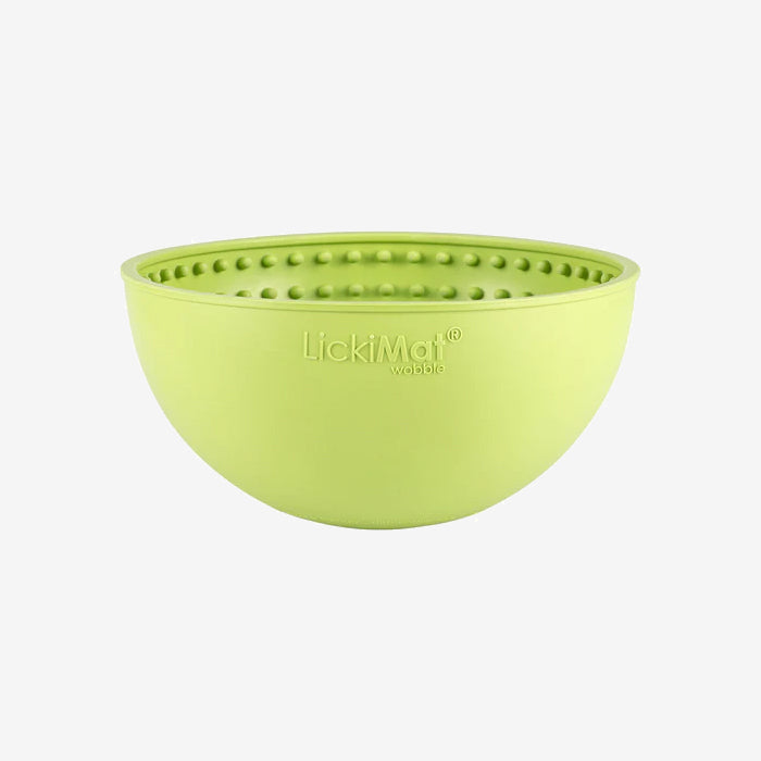 Green silicone bowl with textured interior, labeled "LickiMat wobble," designed for pet enrichment and interactive feeding.