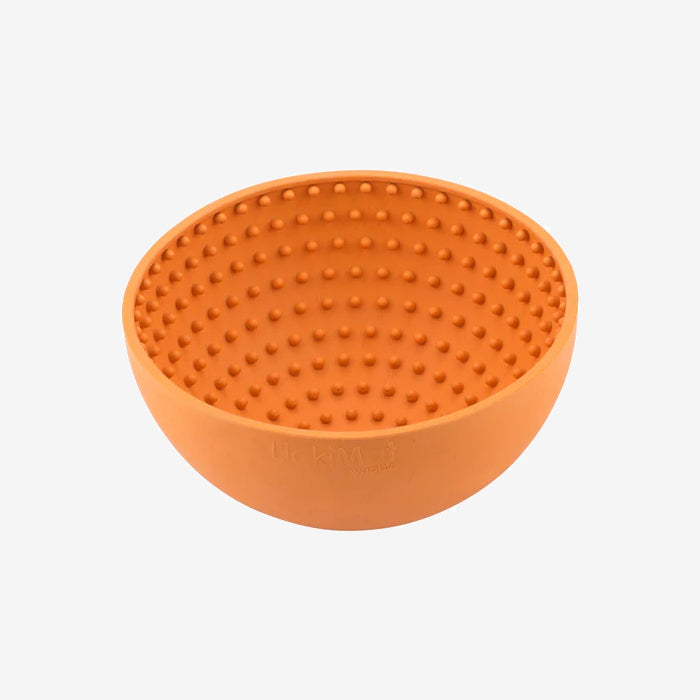 An orange silicone bowl with a dotted interior, designed for enhanced grip and functionality.
