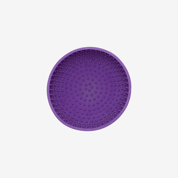 Round purple silicone pad textured with raised dots, ideal for adding grip or stability under items.