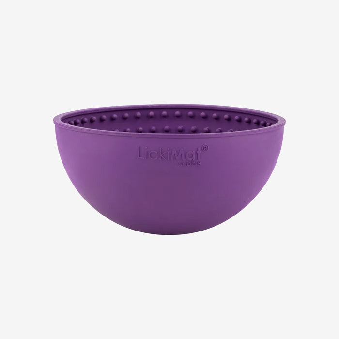 A round, purple LickiMat dog bowl with raised, textured dots for interactive feeding, designed to enhance mealtime enjoyment.