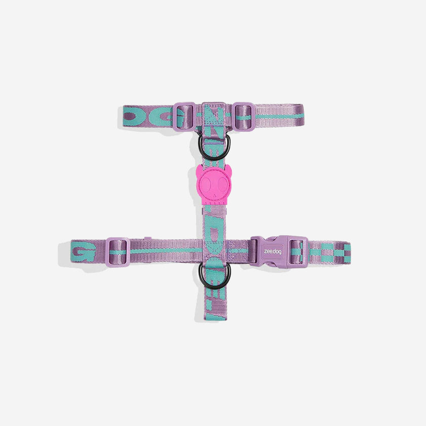A purple and teal patterned dog harness laid out flat in an "H" shape against a white background.
