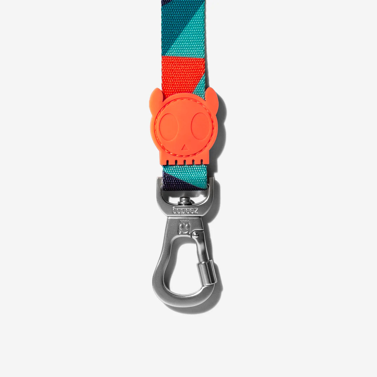 Colourful pet leash with a vibrant pattern, featuring a playful orange skull-shaped buckle and a silver metal clip.