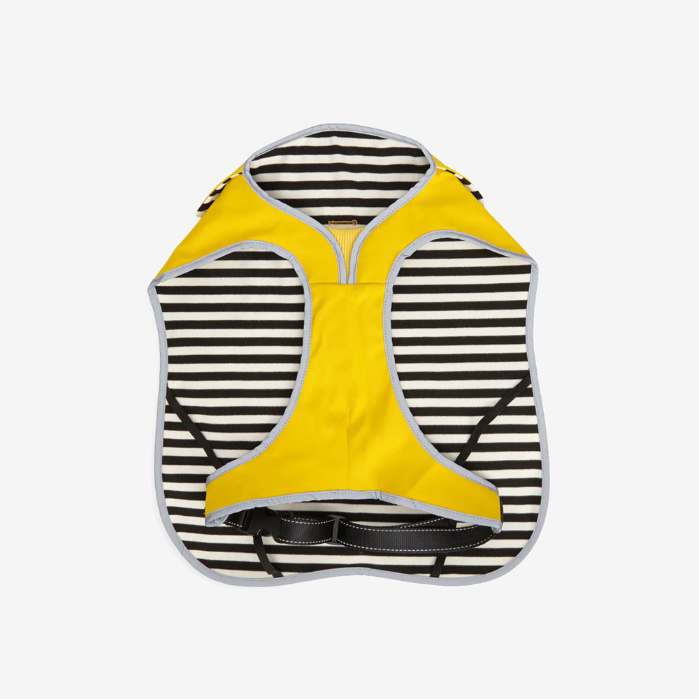 A bright yellow dog coat with a striped black and white interior, featuring a zipper and adjustable straps.