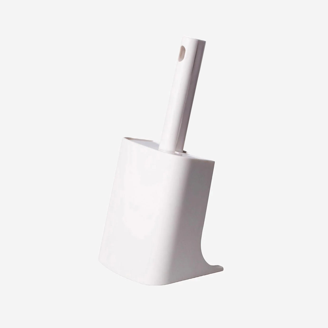 White cat litter scoop with holder on a plain background.