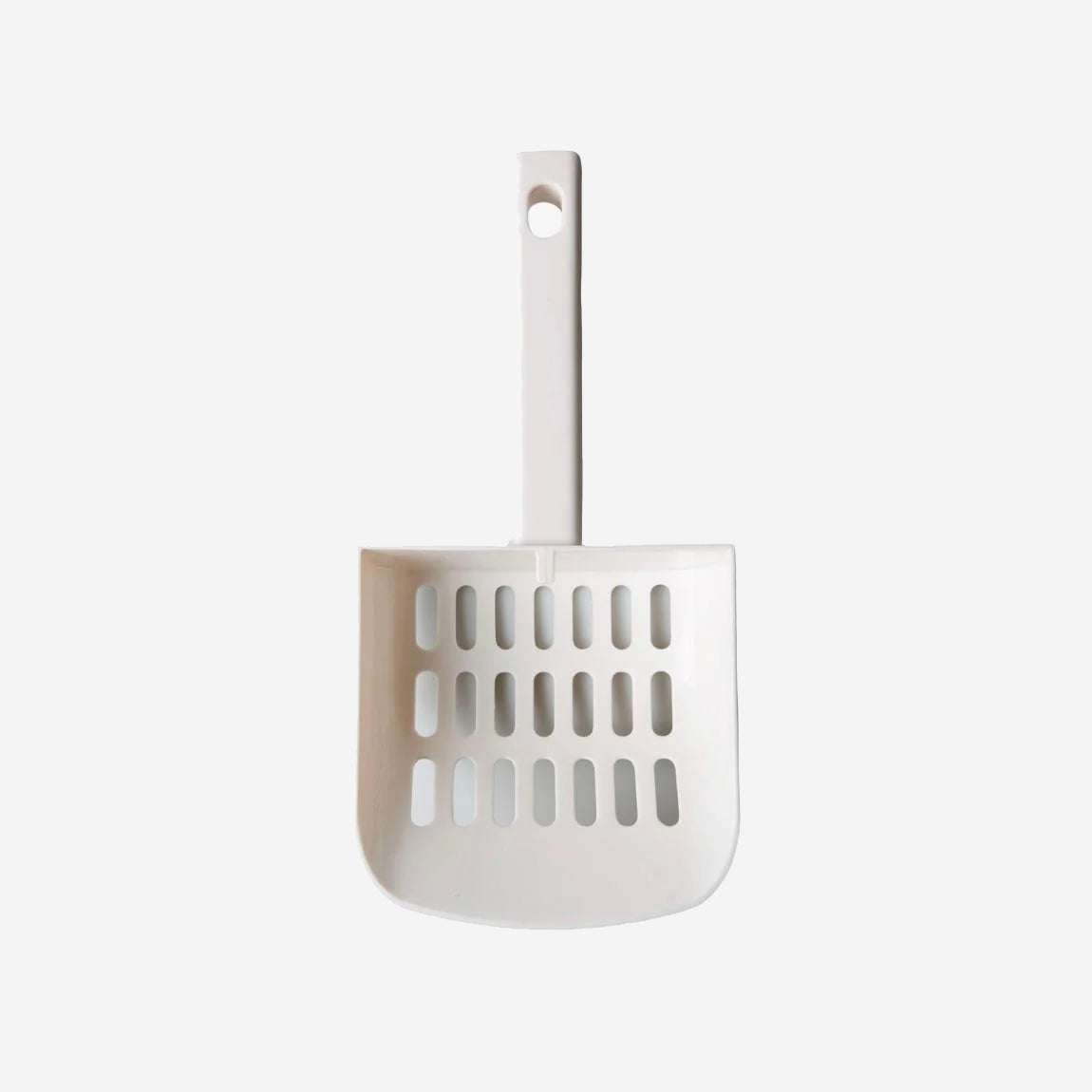 White cat litter scoop with holder on a plain background.